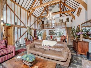 a living room with a couch and a table at The Barn - Uk49371 in Send