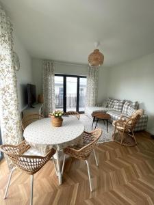 a living room with a table and chairs and a couch at Apartament Aleja Poetów in Chojnice