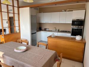 a kitchen with a table with a bowl on it at Terrazza Idrusa in Otranto