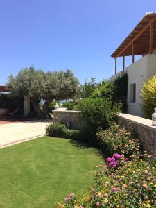 a garden in front of a house with flowers at Xenon Estate in Spetses