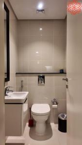 a bathroom with a toilet and a sink at Amazing 1bdr apartment in business bay in Dubai