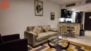 a living room with a couch and a table at Amazing 1bdr apartment in business bay in Dubai