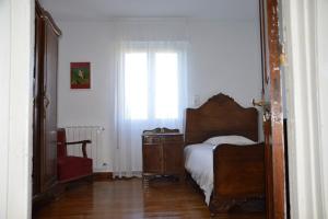 Un dormitorio con una cama y una cómoda y una ventana. en Pepe Pastora - Casa grande, en Arroes