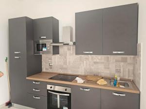 a kitchen with stainless steel cabinets and a sink at Casa LuMaré in Ponza