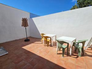 a patio with a table and chairs and a lamp at Casa LuMaré in Ponza