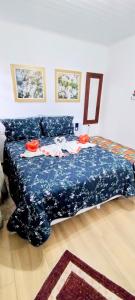 a bedroom with a bed with a blue bedspread at Mouton Blanc Campos do Jordão in Campos do Jordão +43 photos
