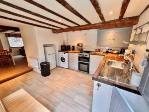 a kitchen with white appliances and a wooden floor at One Threadneedle Street, Dedham in Dedham