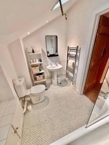 a bathroom with a toilet and a sink at One Threadneedle Street, Dedham in Dedham +11 photos