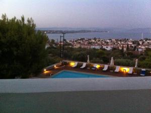 a swimming pool with a view of a city at Xenon Estate in Spetses
