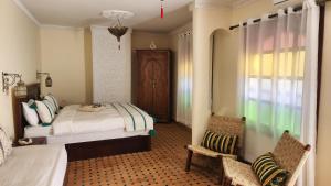 Postel nebo postele na pokoji v ubytování Riad Lily