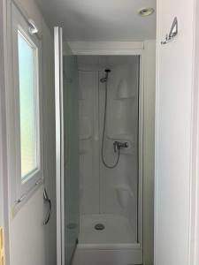 a bathroom with a shower with a glass door at Camp Les Deux in Jouillat