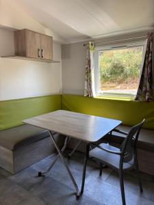 a room with a table and a bench and a window at Camp Les Deux in Jouillat +9 photos