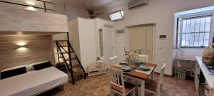 a room with a bed and a table and a bed and a desk at La Salitella in Terracina