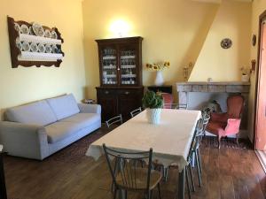 a living room with a table and a couch at Stazzo Gallurese con vista sul golfo di Olbia in Pittulongu +19 photos