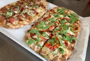 two pizzas sitting on top of a table at Apartmán Libochovice in Libochovice +14 photos