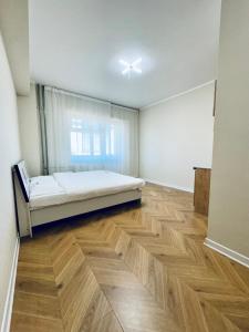 a large room with a bed and a wooden floor at Tsahar geust house in Ulaanbaatar +13 photos