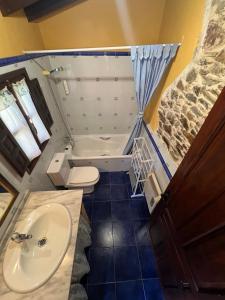 a small bathroom with a sink and a toilet at La Casona del Cura 2, LIRIO in Pravia