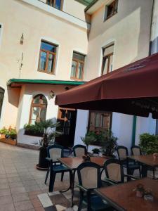 an outdoor patio with tables and chairs and a building at Apartmán Libochovice in Libochovice