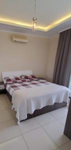 a bedroom with a bed in a room at MODA MARİNE LUXURY HOMEs in Alanya +18 photos