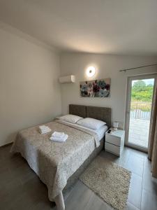 a bedroom with a bed and a window at Villa Anna in Medulin +14 photos