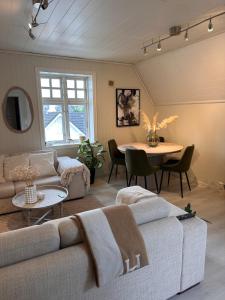 a living room with a couch and a table at Cozy top floor apartament in Stavanger