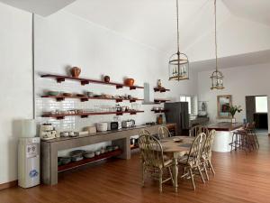 a kitchen and dining room with a table and chairs at Tropical Garden Luxury Villa, Koh Phangan in Koh Phangan
