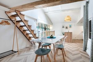 a dining room with a table and chairs and a staircase at Duplex cosy centre historique in Limoges