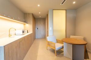 a kitchen with a wooden table and a table and a chair at Reina Victoria La Plaza 2 in Alicante