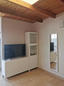 een woonkamer met een flatscreen-tv aan een witte muur bij Casa El Alpendre de Temisas - Recién renovada in Temisas