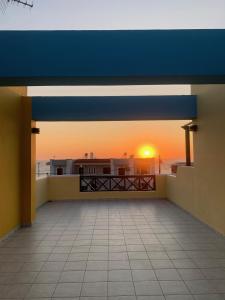 a view of the sunset from the balcony of a house at Dilina Studios in Arkasa