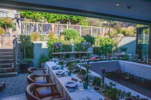 a patio with a table and chairs and a table at Blonde Hedgehog in Alderney