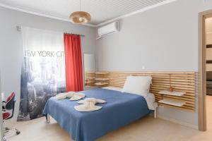 a bedroom with a blue bed with towels on it at My Summerhouse with jacuzzi in Kremasti