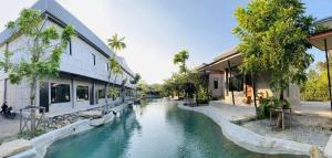 a river in the middle of a street with buildings at Ban Nokhook New in Chanthaburi