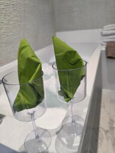 two wine glasses with green leaves in them on a counter at Musselburgh Links B&B in Musselburgh