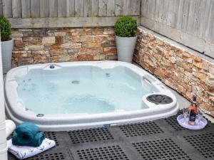 a jacuzzi tub in a backyard with two plants at 2 Bed in Westward Ho 65074 in Northam