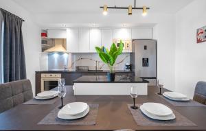 a kitchen and dining room with a table and chairs at Holiday home Vodice in Vodice