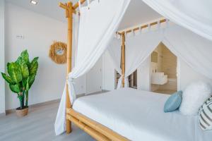 a bedroom with a bed with a canopy at Dino Villa with ocean view in Casal do Cigano +36 photos