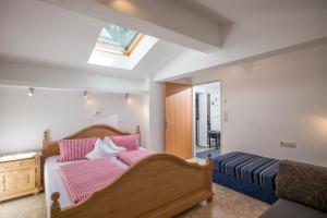 a bedroom with a large bed and a skylight at Sonnenappartement in Mayrhofen