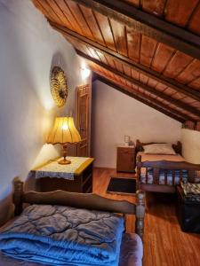 a bedroom with a bed and a table with a lamp at Relaxing Historic House on the Adriatic coast in Lukovo