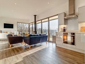 a kitchen and living room with a couch and a table at 2 Bed in East Bergholt 82397 in East Bergholt