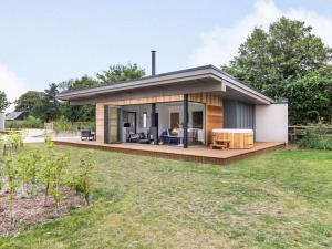 a small house with a large deck in a yard at 2 Bed in East Bergholt 82397 in East Bergholt
