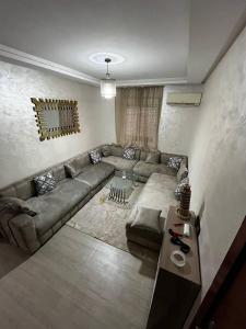 a living room with a couch and a table at appartement Marrakech in Oulad Akkou