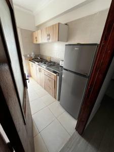 a kitchen with a refrigerator and a stove at appartement Marrakech in Oulad Akkou