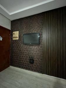 a flat screen tv on a wall in a room at appartement Marrakech in Oulad Akkou