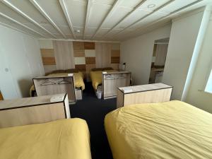 a room with four beds in it at Partypad Newcastle Central in Saint Peters