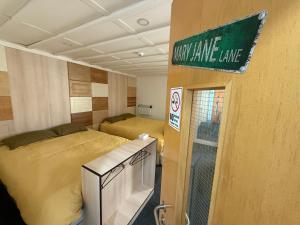a room with two beds and a sign that says new lane lane at Partypad Newcastle Central in Saint Peters +87 photos
