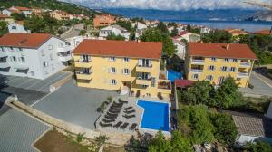 an aerial view of a building with a swimming pool at Apartments Gorica 2 in Baška