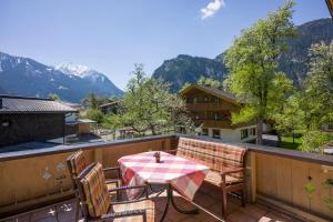 a table and chairs on a balcony with mountains at Sonnenappartement in Mayrhofen