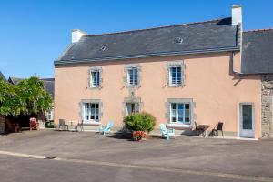 ein Gebäude mit Stühlen und Tischen davor in der Unterkunft Gite Glycine, Kerantum in Mahalon