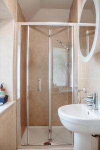 a bathroom with a shower and a sink at Spacious Holiday Home with Free Parking in Harrogate +34 photos